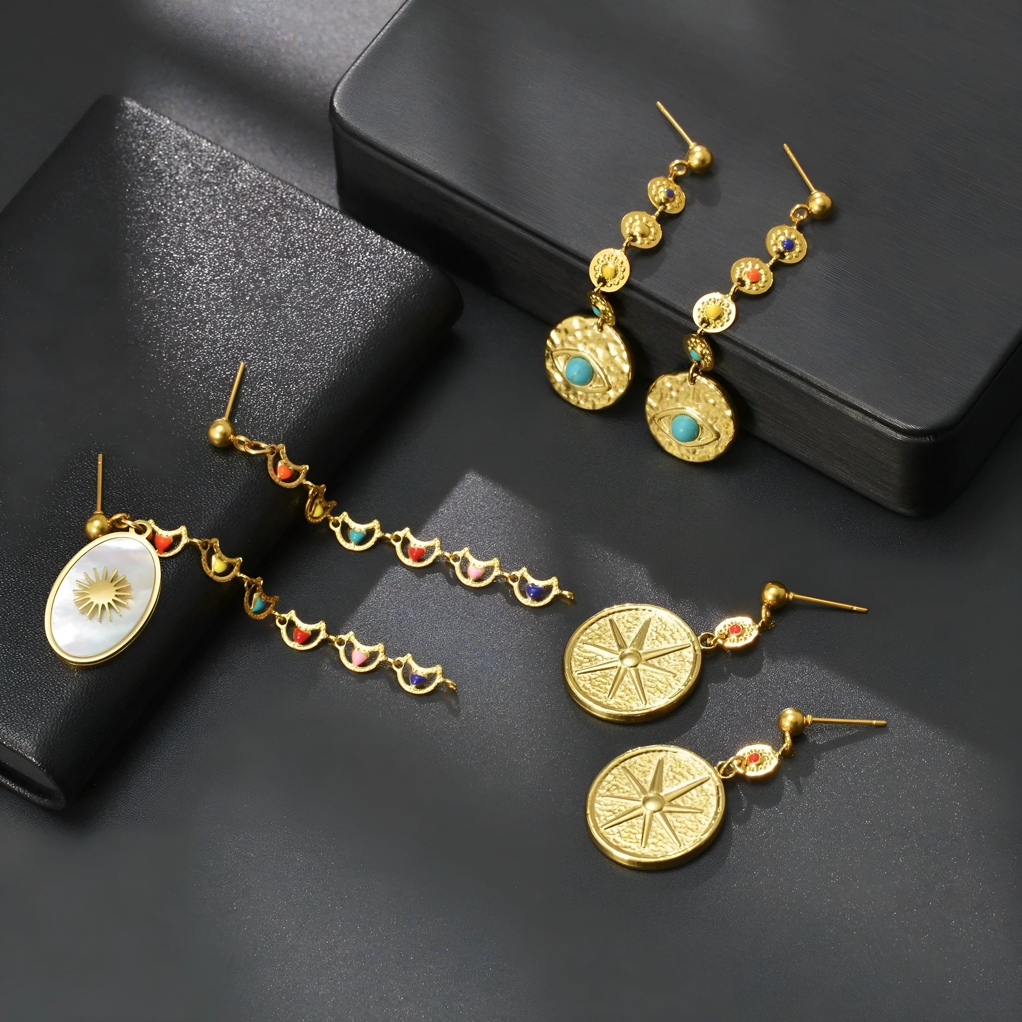 Geometric stainless steel statement earrings showing star, eye, and sun design options.