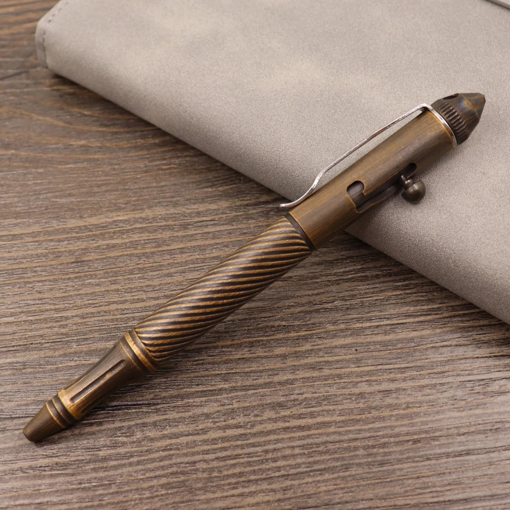 Brass tactical pen with bolt-action mechanism and retro brushed finish