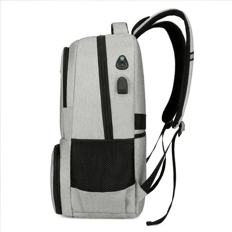 Light grey oxford cloth insulated backpack with curved shoulder straps and top handle.