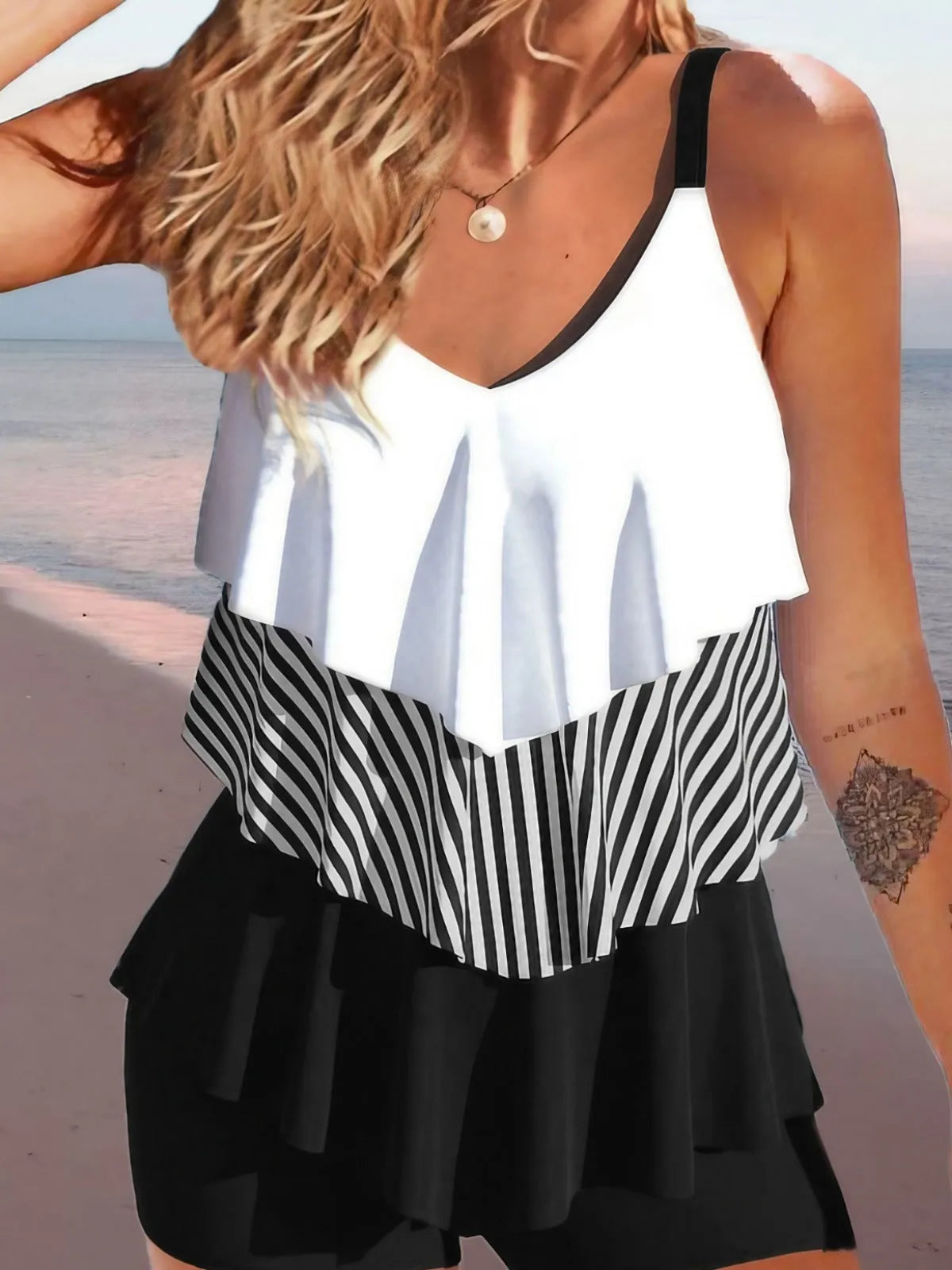 Women's sleeveless bikini swimsuit with spaghetti straps and ruffle detailing in floral pattern