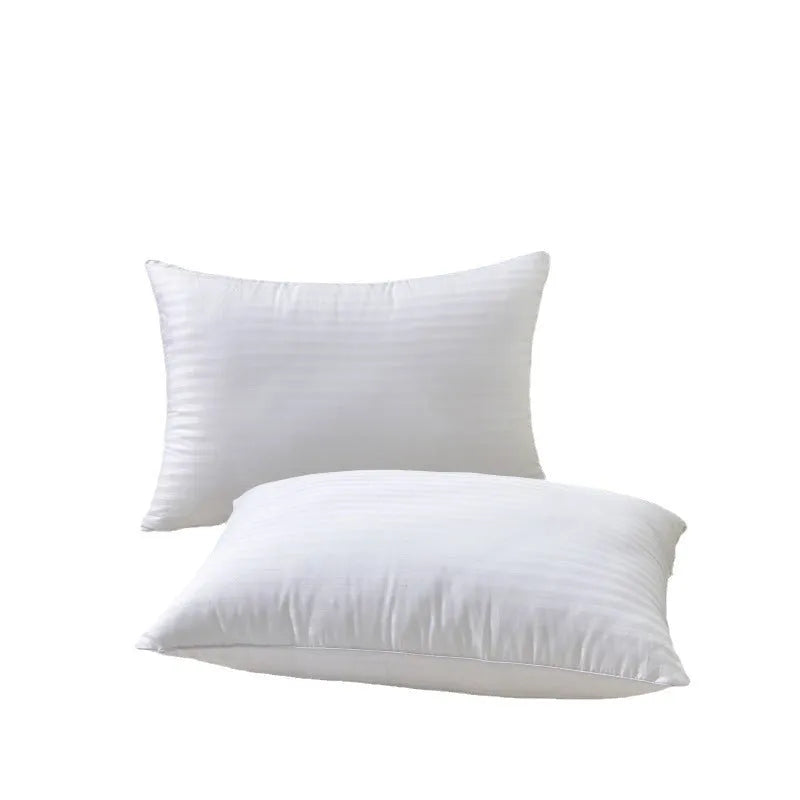 White hotel cotton satin stripe pillow with feather and cotton filling on a bed.