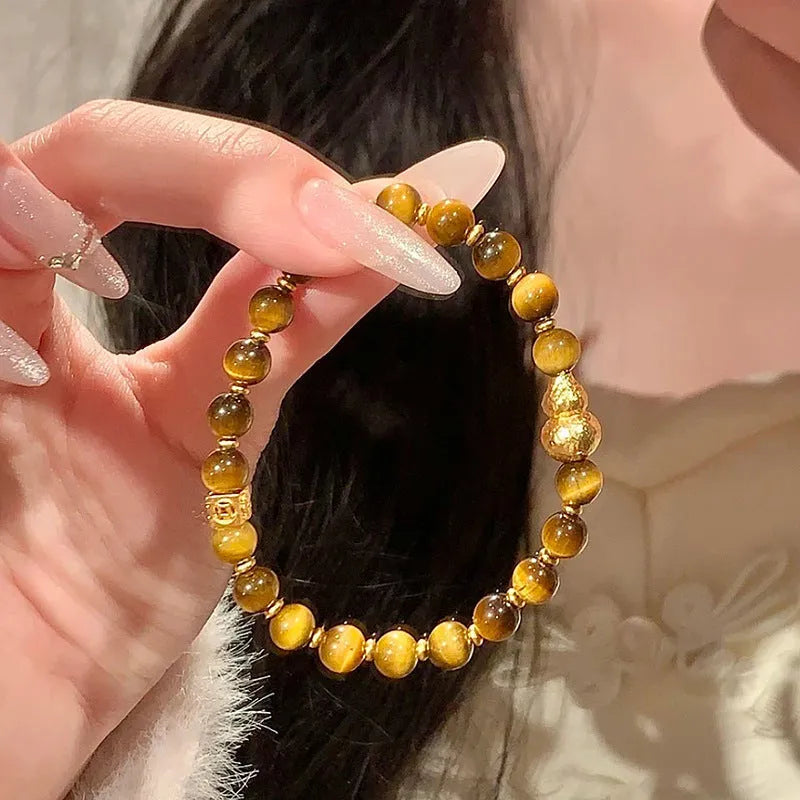 Natural yellow tiger's eye and Hetian jade bracelet with U-shaped bead design showing golden gourd pattern