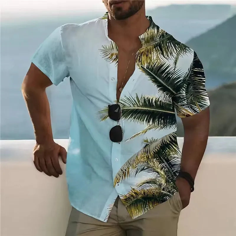 Man wearing a loose-fitting short-sleeve shirt with a colourful floral print pattern.