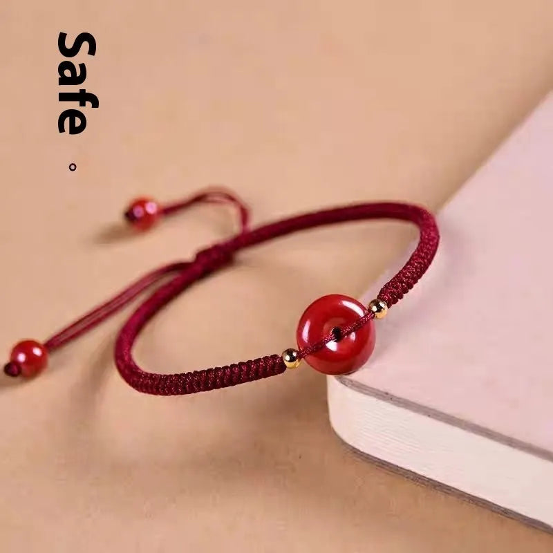 Cinnabar safety buckle bracelet with heart-shaped pendant on adjustable rope cord