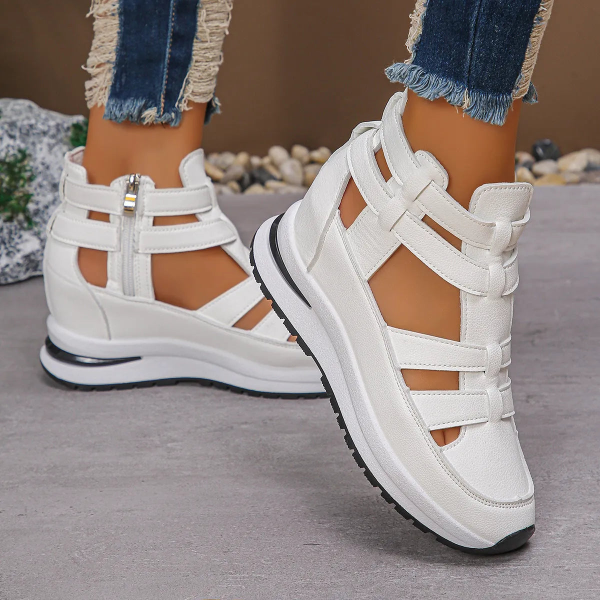 Women's black close-toed hollow-out platform sandals with a Velcro strap on a white background.