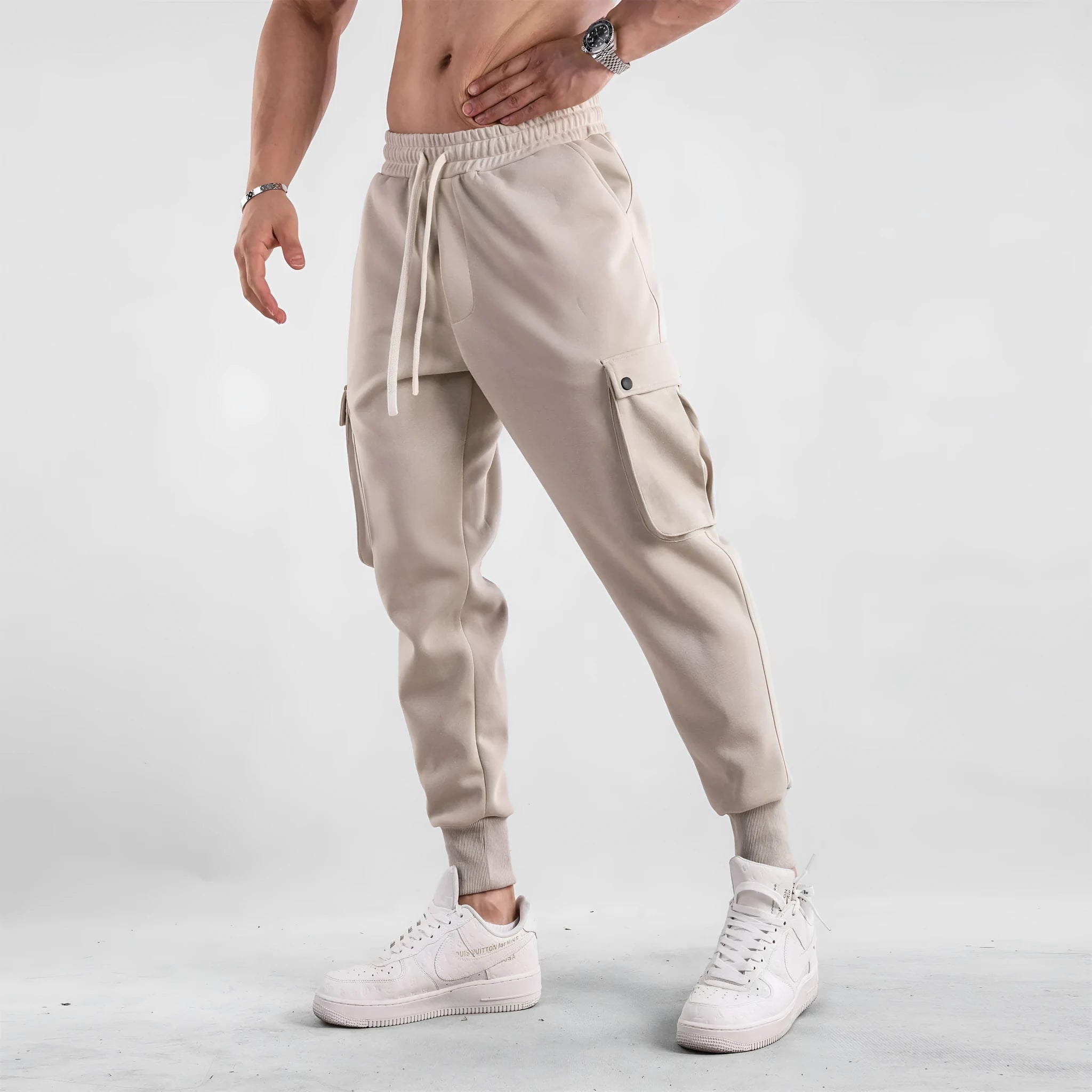 Men's loose light gray cotton trousers with ankle-tied cuffs and multiple pockets