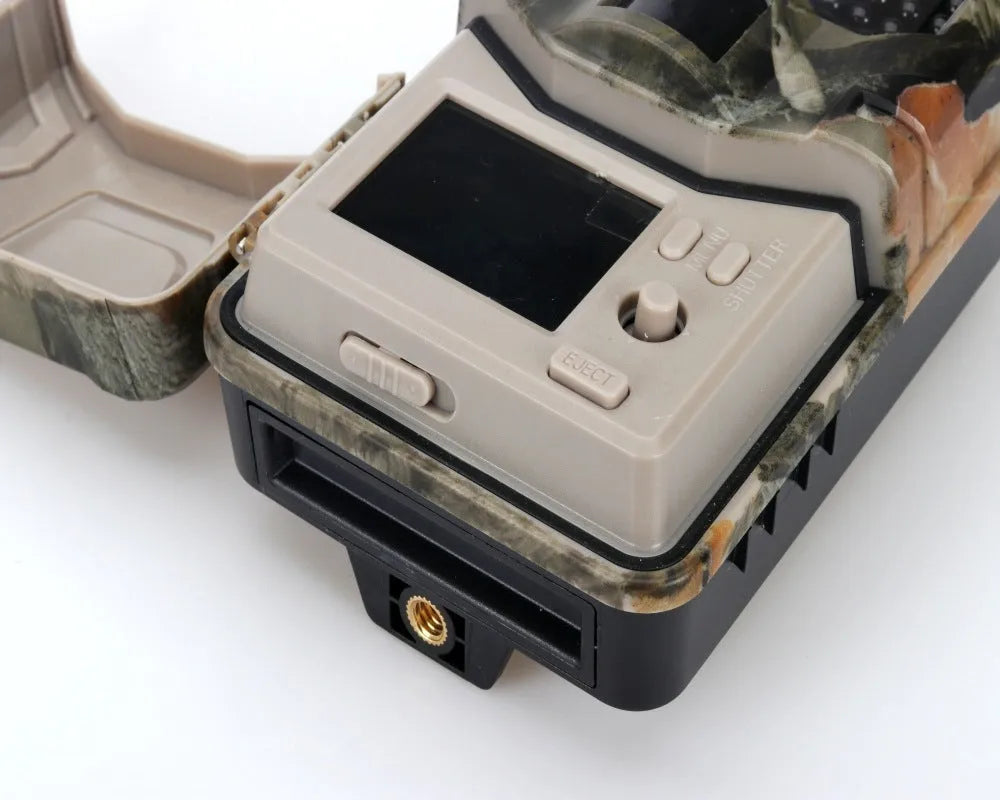 Camouflaged outdoor hunting camera with infrared LEDs, showing compact design for wildlife and security monitoring.