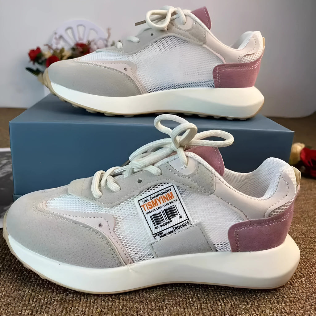 Women's low-top retro sneaker in grey with round toe, rubber sole, and mesh lining.