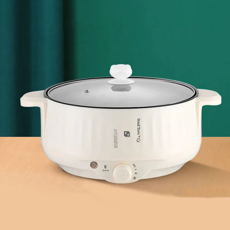 White and green non-stick electric hot pot appliance on a kitchen countertop with multiple size options.