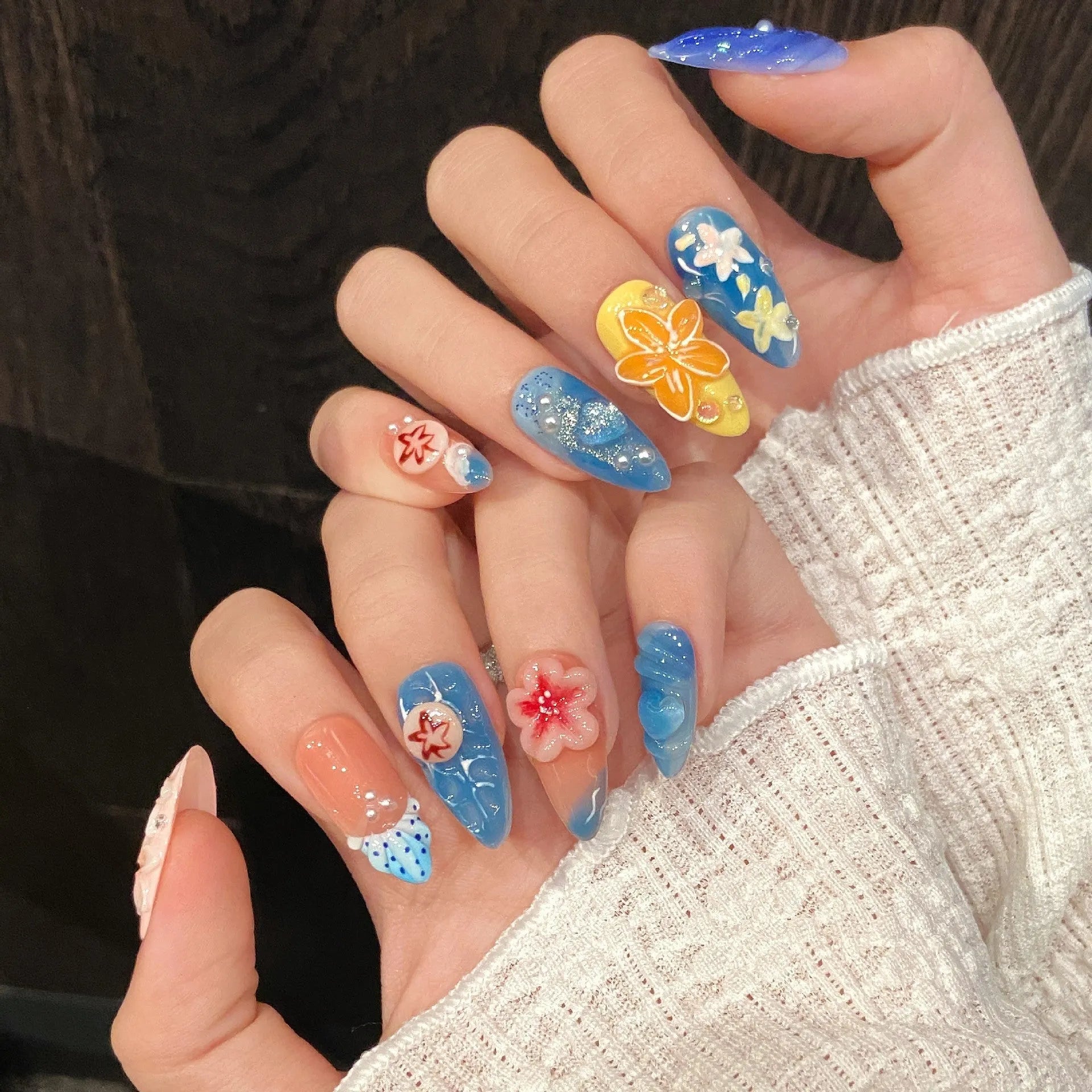 Three-dimensional carved jellyfish design on plastic marine-style wearable armour in almond nail colour.