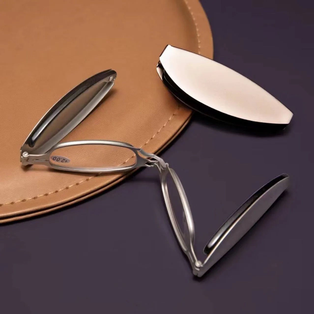 Folding pocket presbyopic glasses in black and silver retro frames with ring detailing