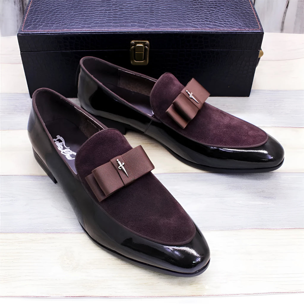 Men's black patent leather low-top shoes with a gold tassel detail and rubber sole.