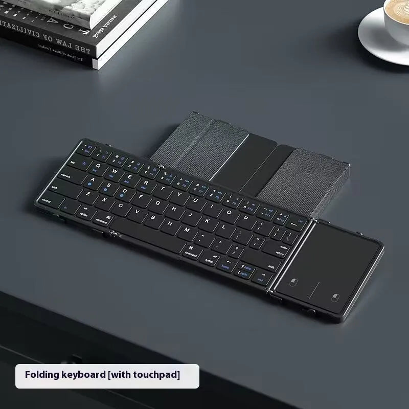 Black folding Bluetooth keyboard collapsed to compact size for mobile phones and tablets