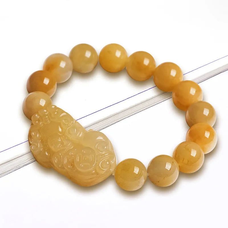 Carved Jinsi Jade money bracelet in Golden Thread Jade colour showing texture and bead detail.