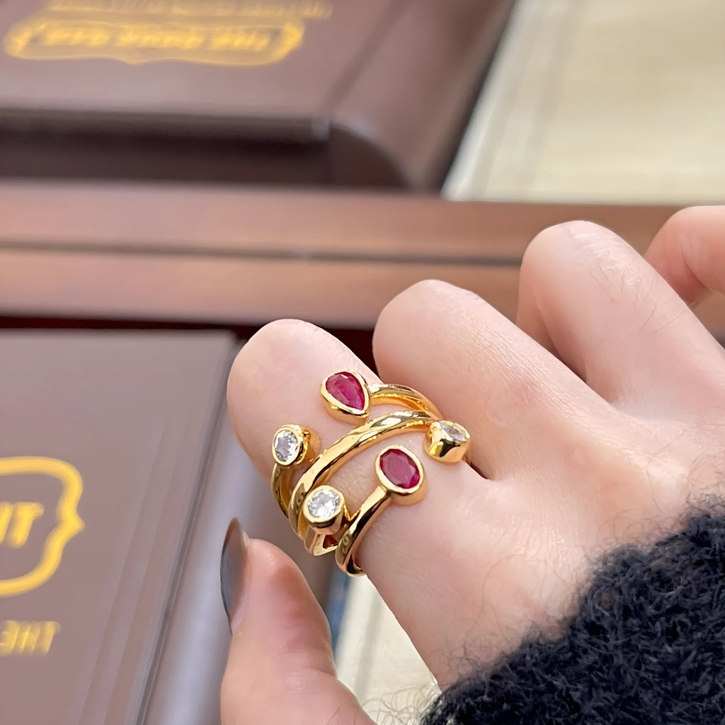 Double-headed irregular cross diamond ring in two-tone colours on a copper base.