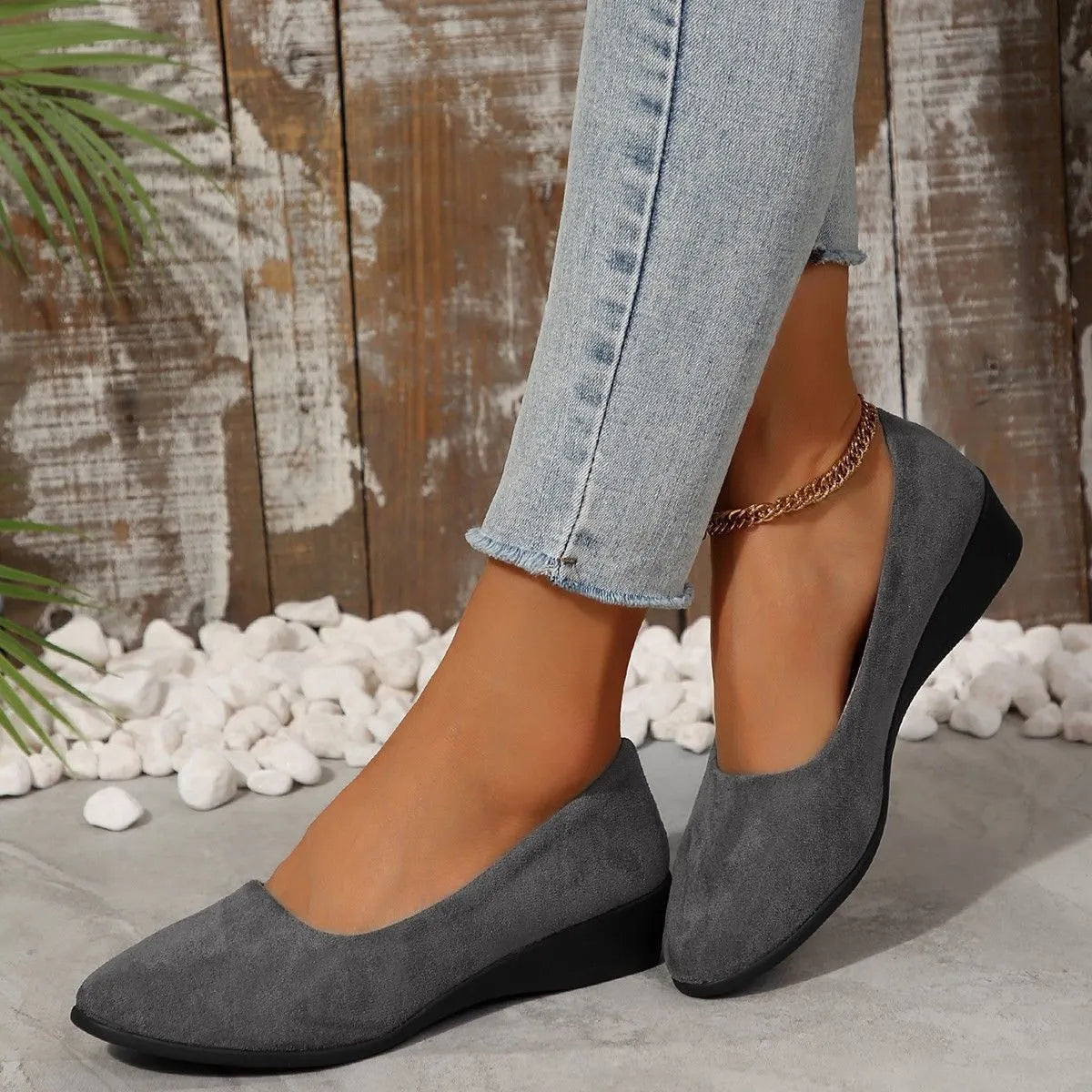 Women's suede wedge pumps in light brown colour showing shallow mouth design and low wedge heel