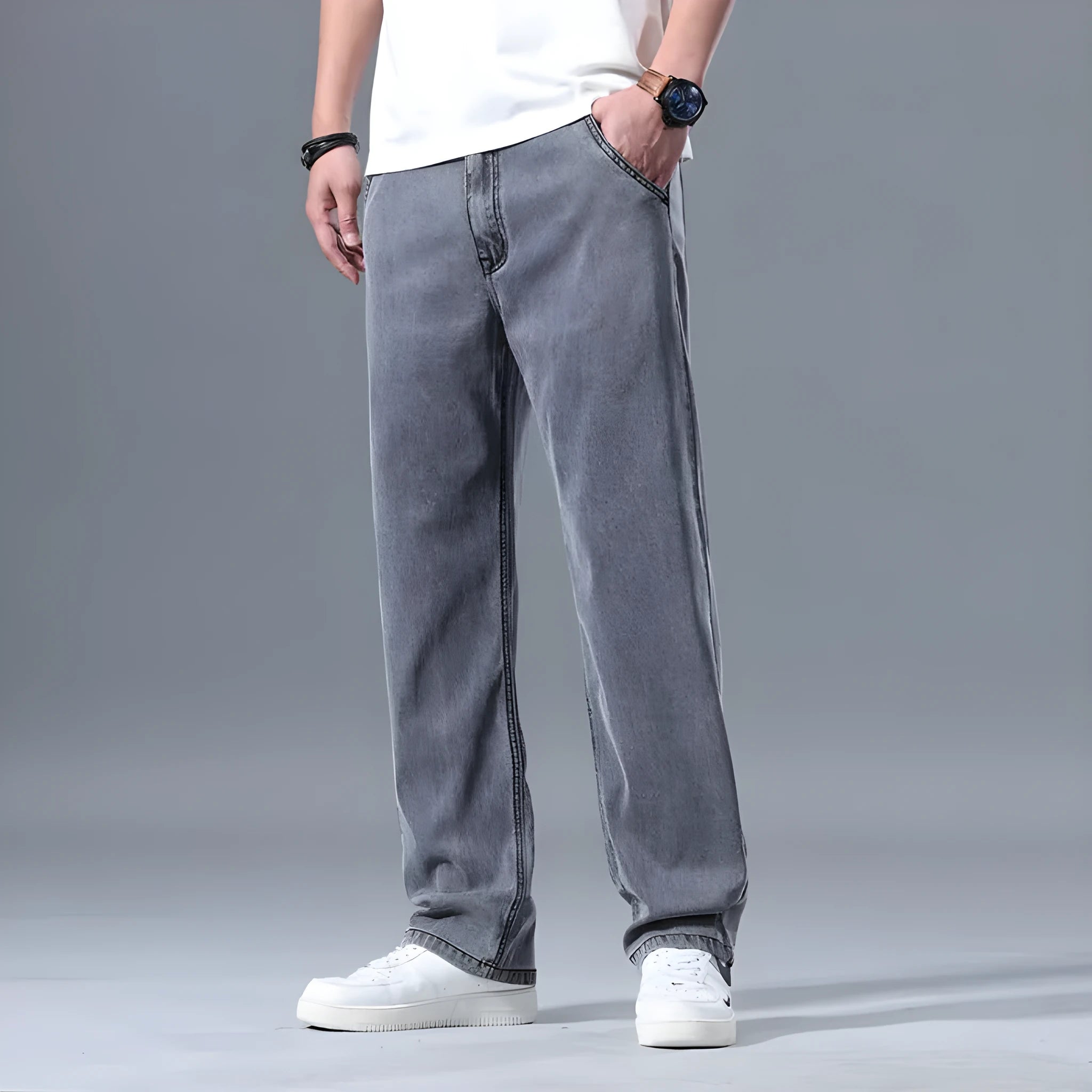 Men's loose fit straight leg lyocell jeans in light blue on a neutral background.