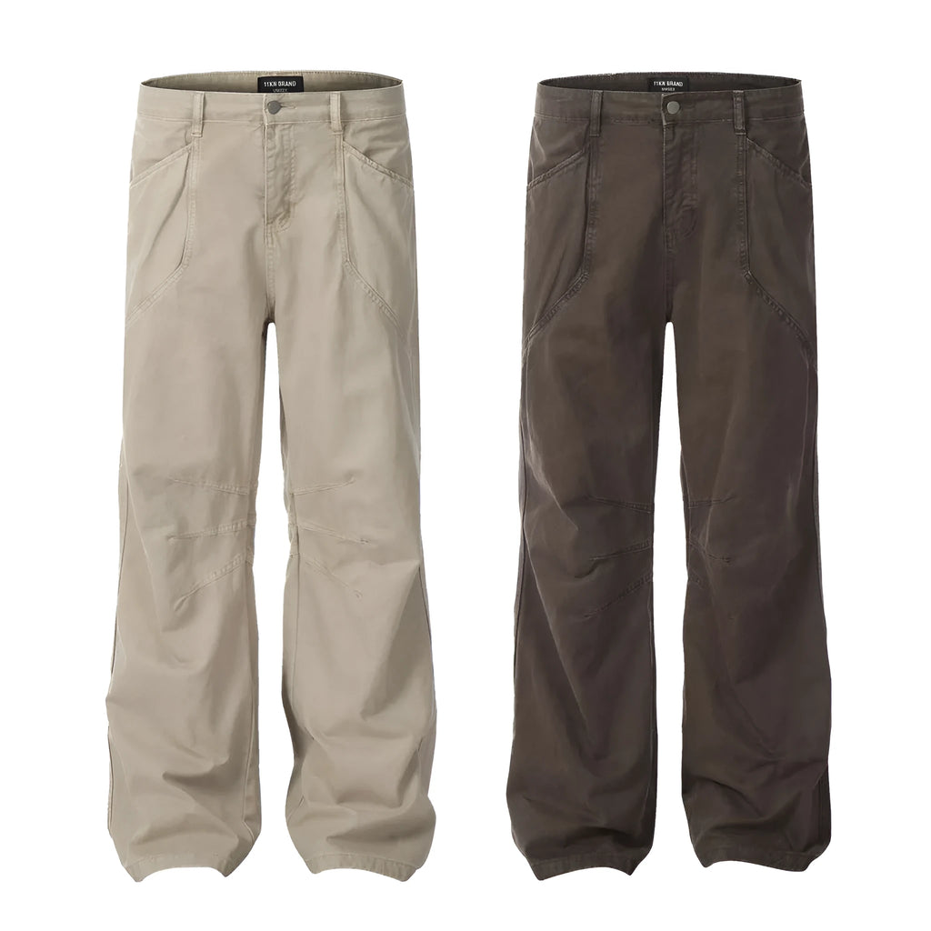 Men's brown loose straight-leg trousers with high waist and wide leg opening on a hanger