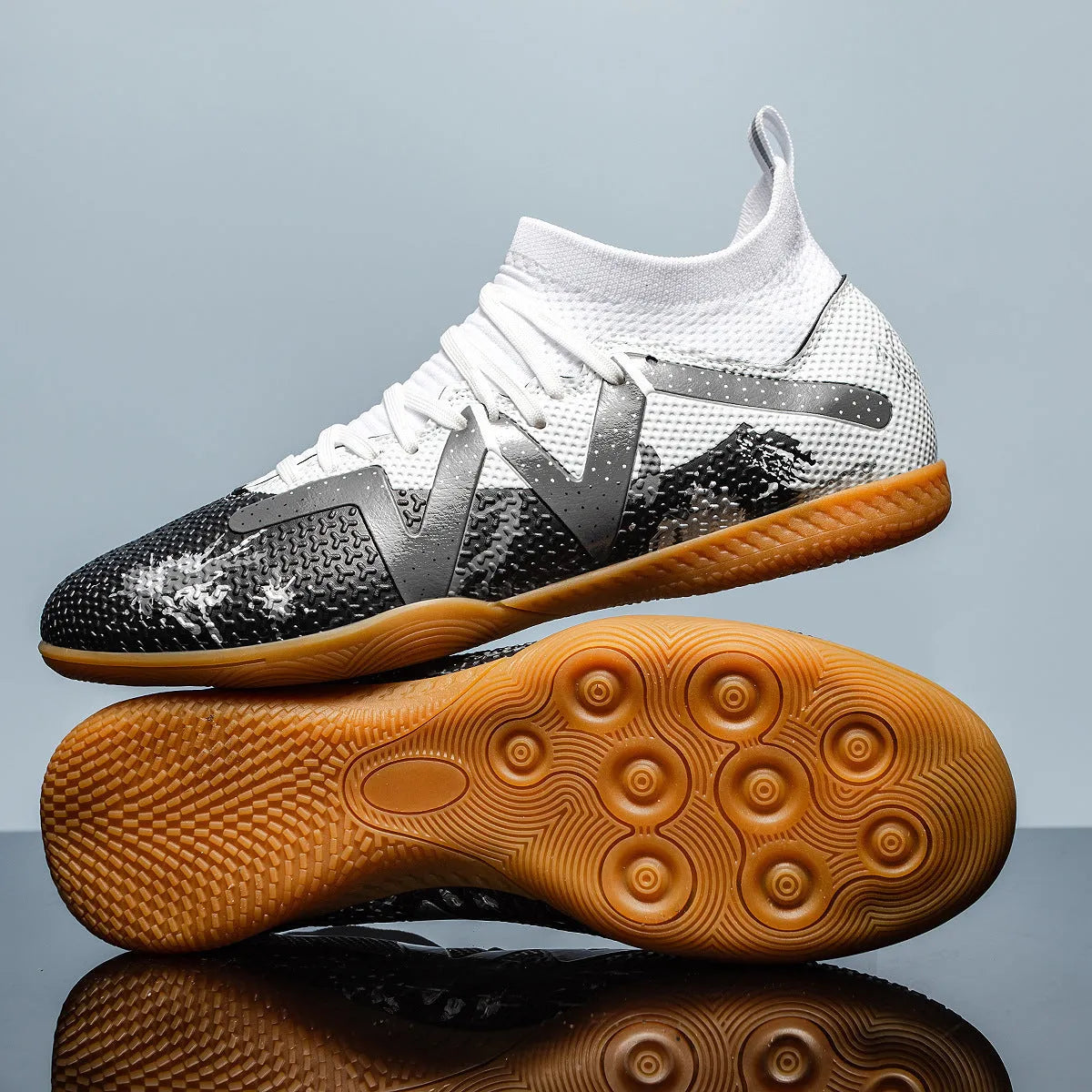 Adult low-top football boots with non-slip rubber outsole, available in black and yellow, white, and black colourways.
