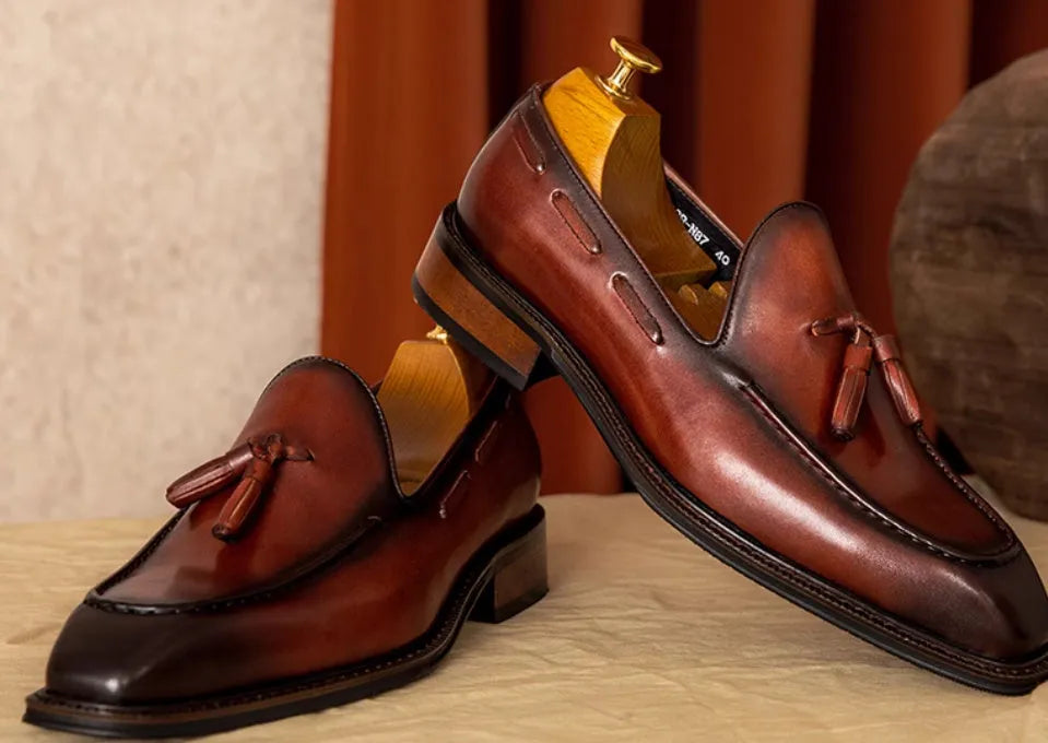 Men's black genuine leather slip-on loafers with a polished finish and rubber sole
