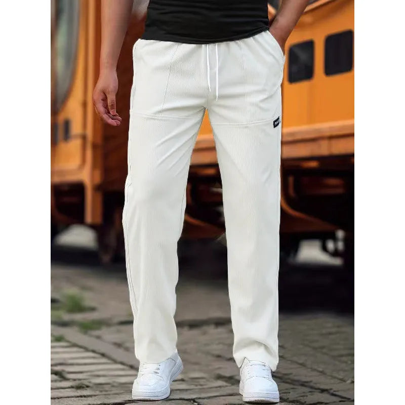Men's straight-leg lightweight polyester trousers in light grey colour, laid flat showing front design