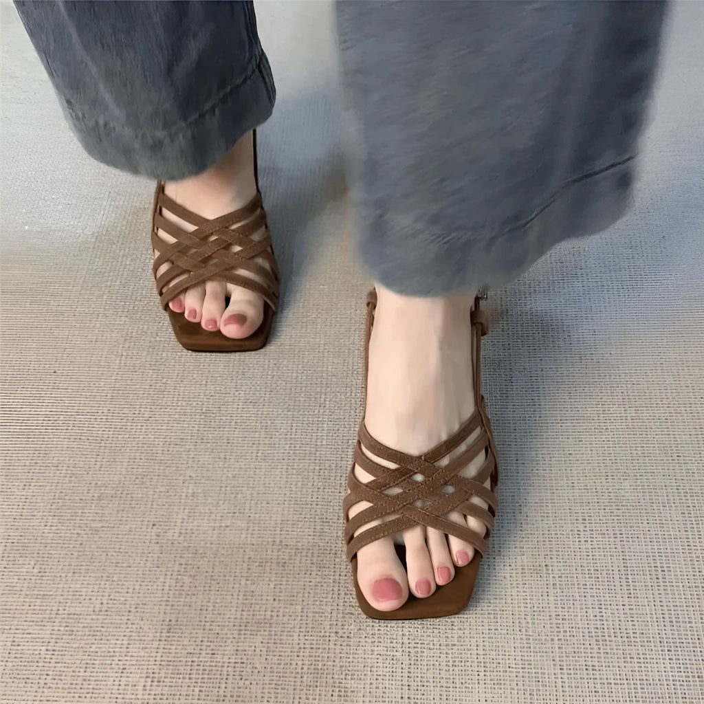 Retro style women's sandals with thin cross straps, ankle buckle, square toe, and a mid-height heel.