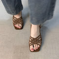 Retro style women's sandals with thin cross straps, ankle buckle, square toe, and a mid-height heel.