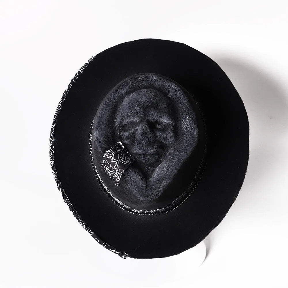 Handmade wool felt Halloween hat with a pointed conical crown in a skull design.