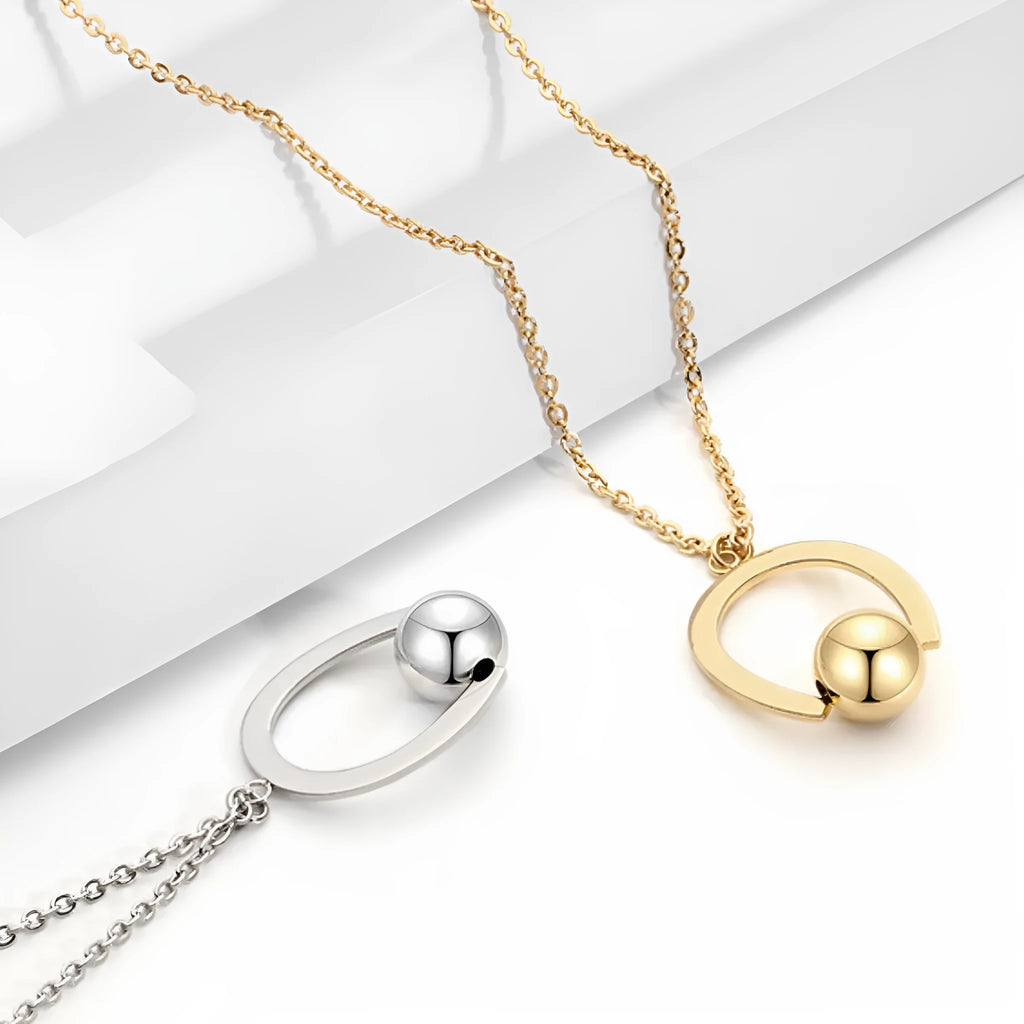 Stainless steel necklace with geometric pendant on a cross chain, in gold or silver colour.