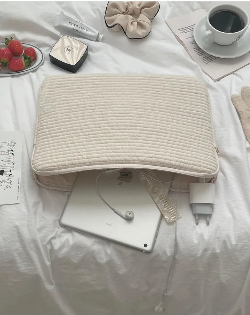 Black and white cotton cloth clutch-style laptop bag for tablets, showing internal coin pocket.
