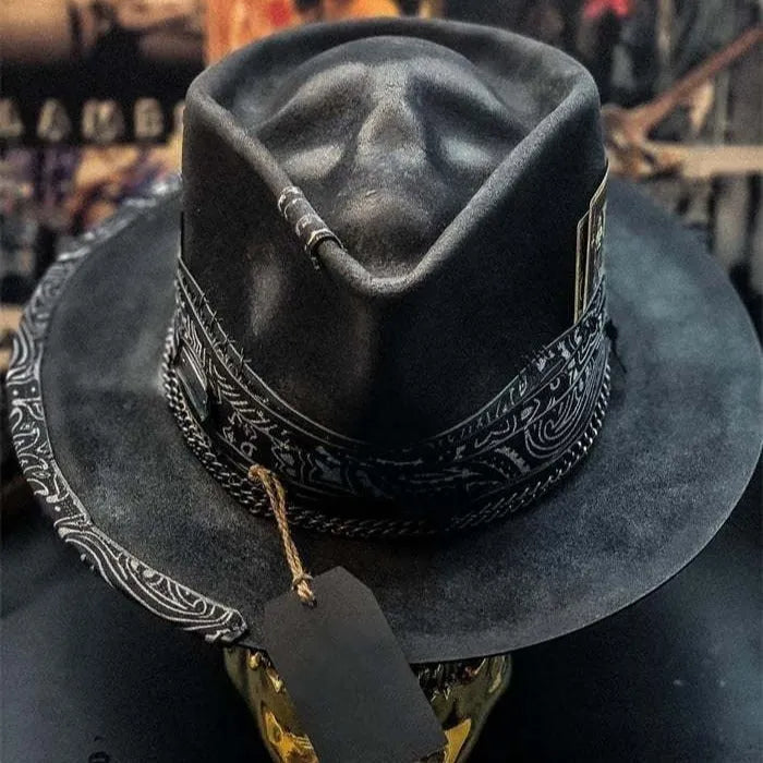 Handmade wool felt Halloween hat with a pointed conical crown in a skull design.