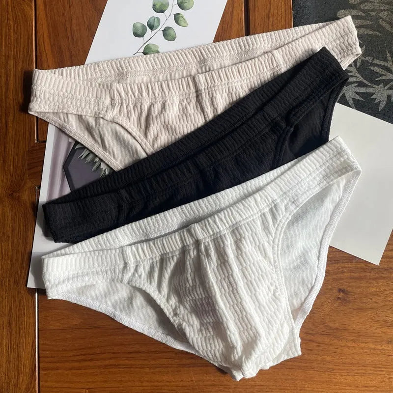 Men's solid colour cotton triangle underwear briefs in mid-waist design on a white background