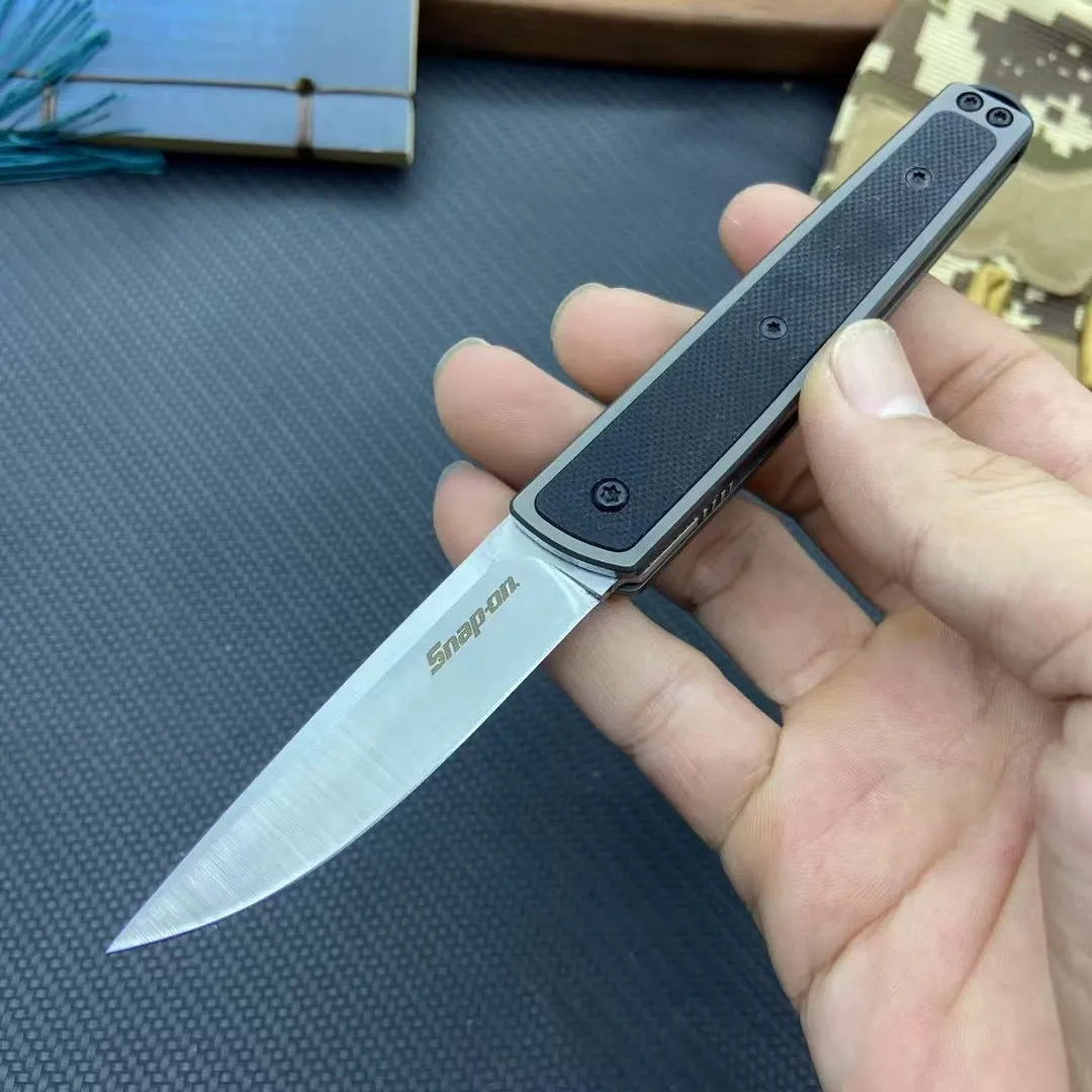 Folding fruit knife with stainless steel blade in black, brown, or red colour options showing closed and open positions