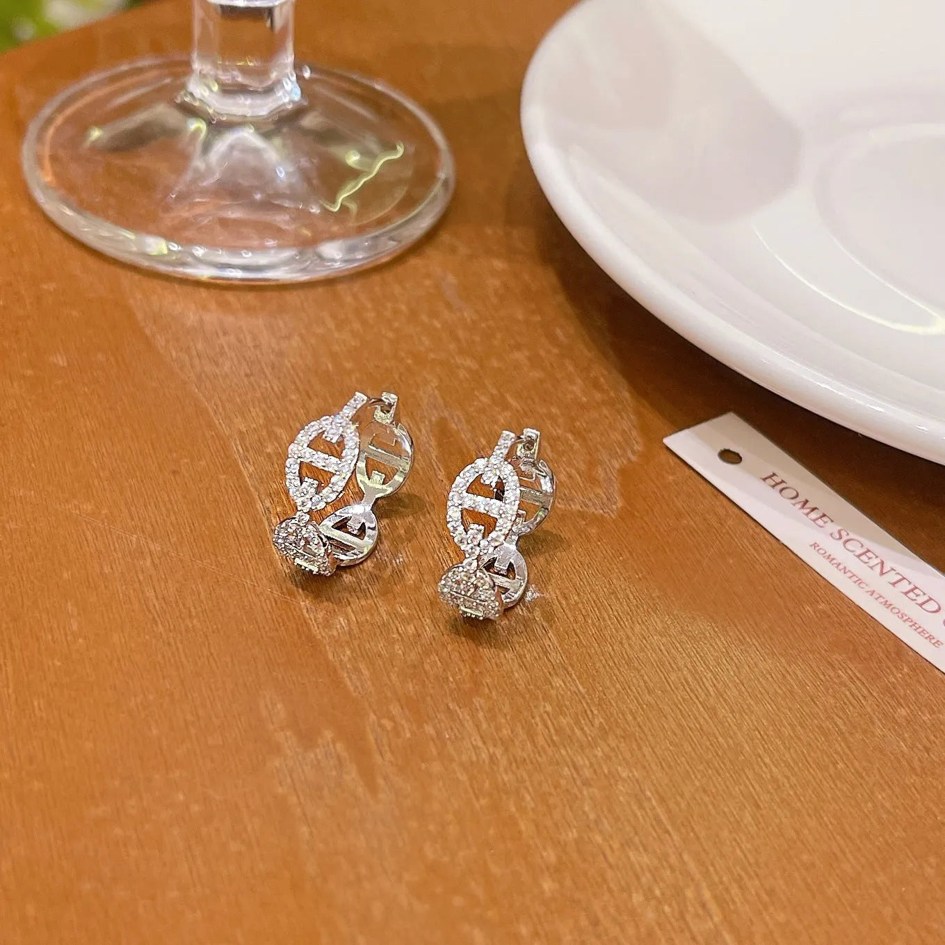 Ladies diamond-effect drop earrings in silver, gold, and rose gold electroplated finishes.