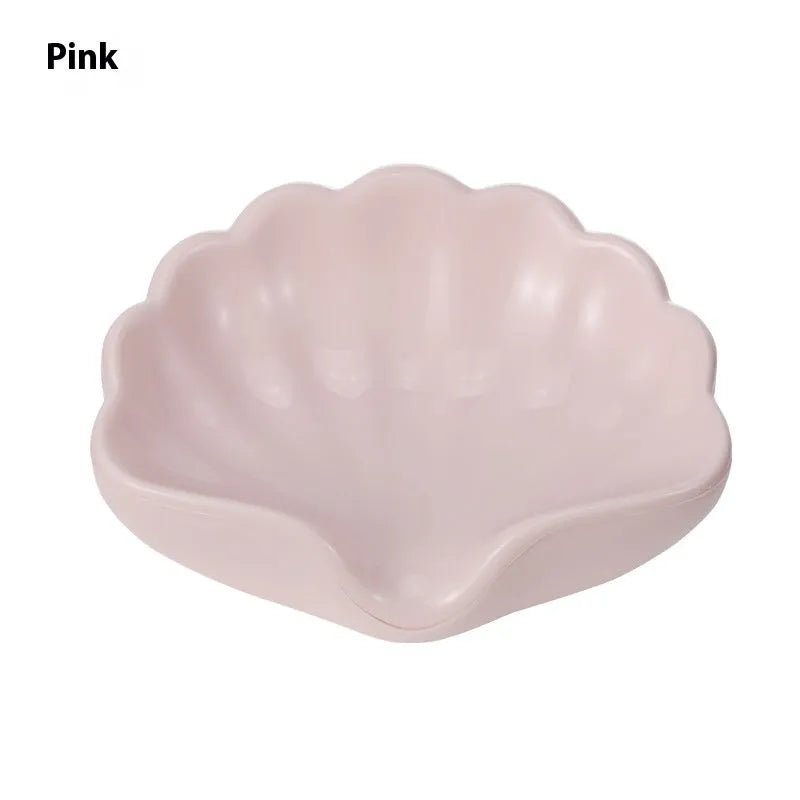 Shell-shaped plastic soap dish in white or pink for bathroom use
