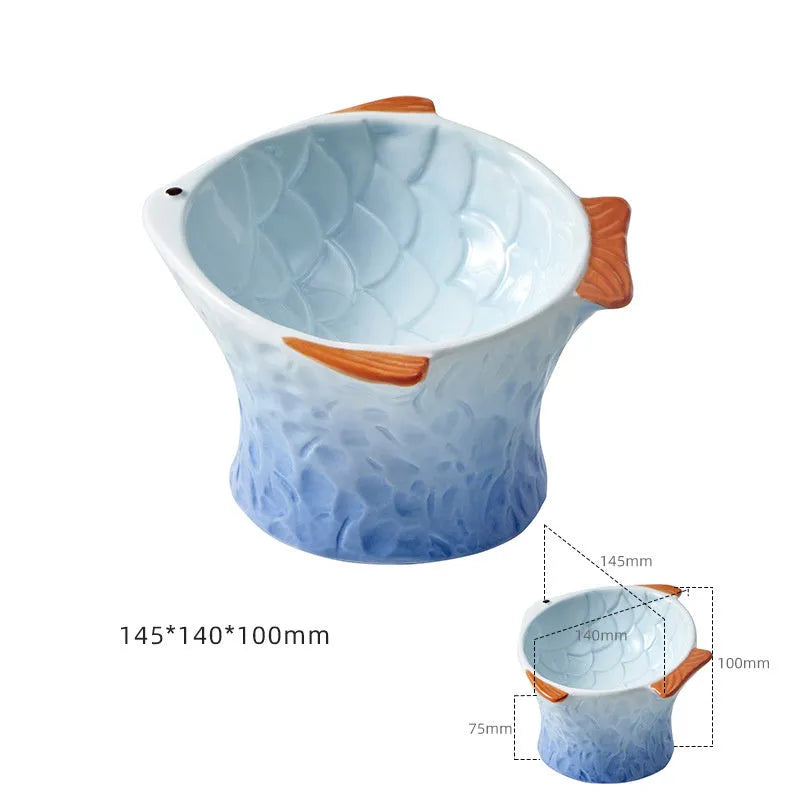 Blue fish-shaped ceramic elevated cat bowl with tilted design on a non-slip base.