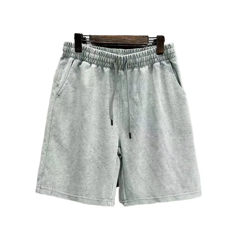 Men's loose-fit cotton casual shorts in distressed style, shown in charcoal black.