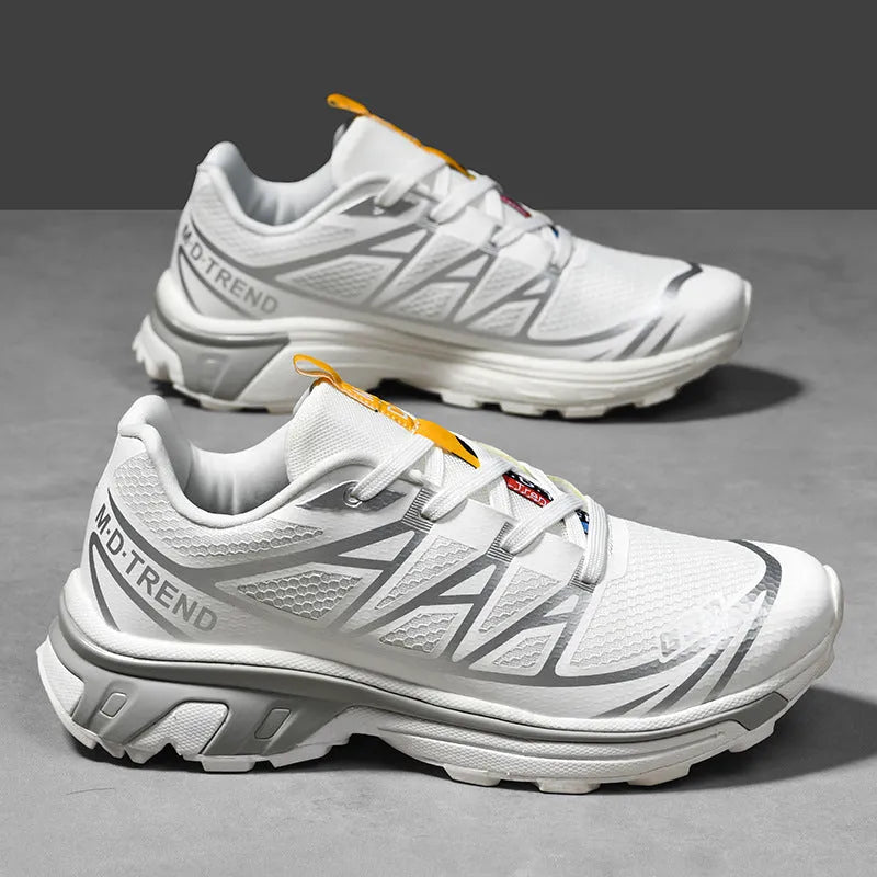 Low-top hiking shoes in khaki with rubber soles and front lace-up closure.