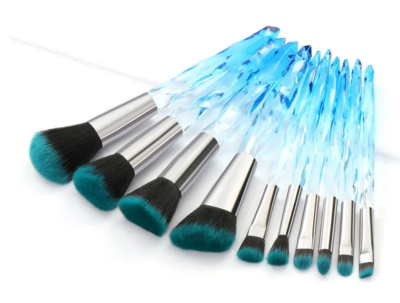 Ten clear crystal diamond shank foundation brushes with artificial fibre heads, shown in a set.