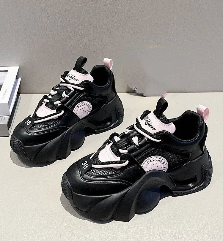 Women's pink casual sneakers with cross strap design and thick sole showing side profile