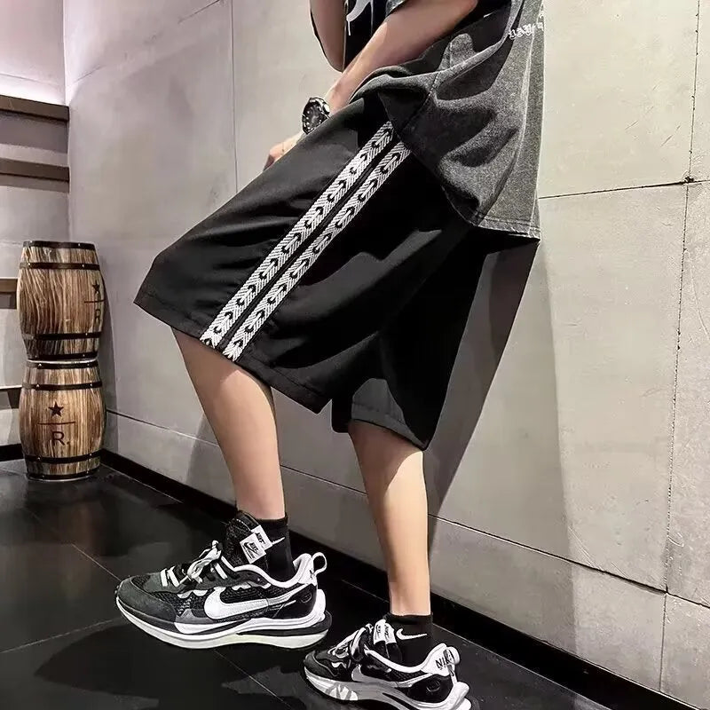 Men's loose fit track pants in black colour with elastic waistband and baggy leg cut