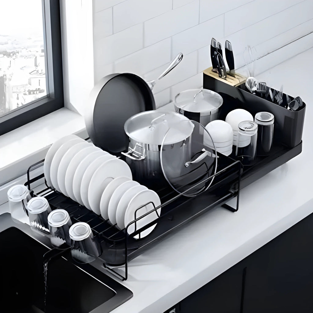 Retractable foldable kitchen dish drain rack for cutlery and cups on a countertop.
