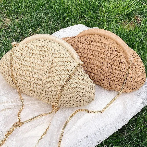 Beige shell-shaped straw shoulder bag with chain strap and woven texture.