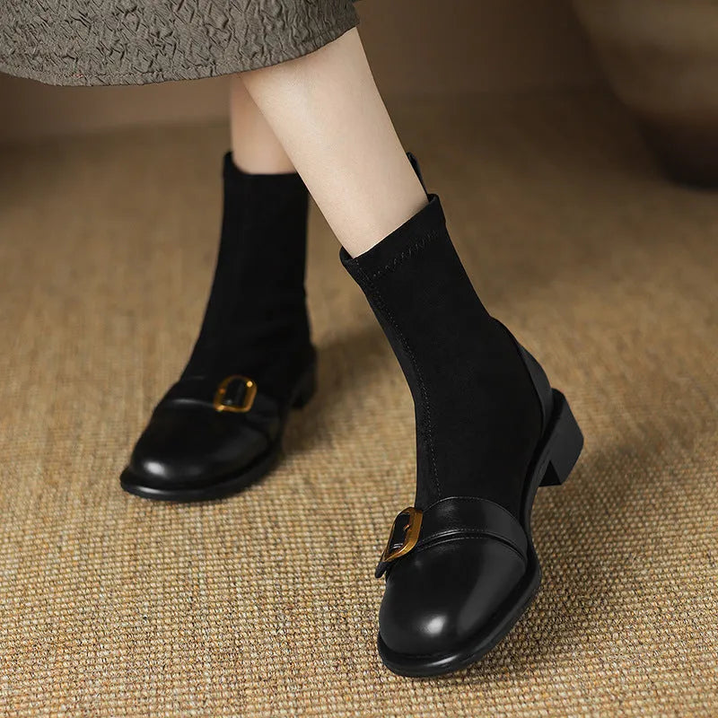 Women's black low-heel Martin ankle boots with front lace-up and belt buckle detail stitching.