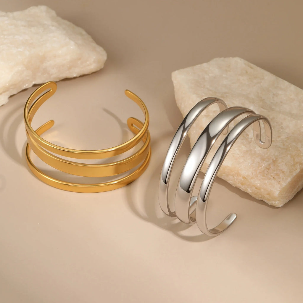 A geometric line design stainless steel bracelet with a simple opening clasp, shown in a gold electroplated finish.