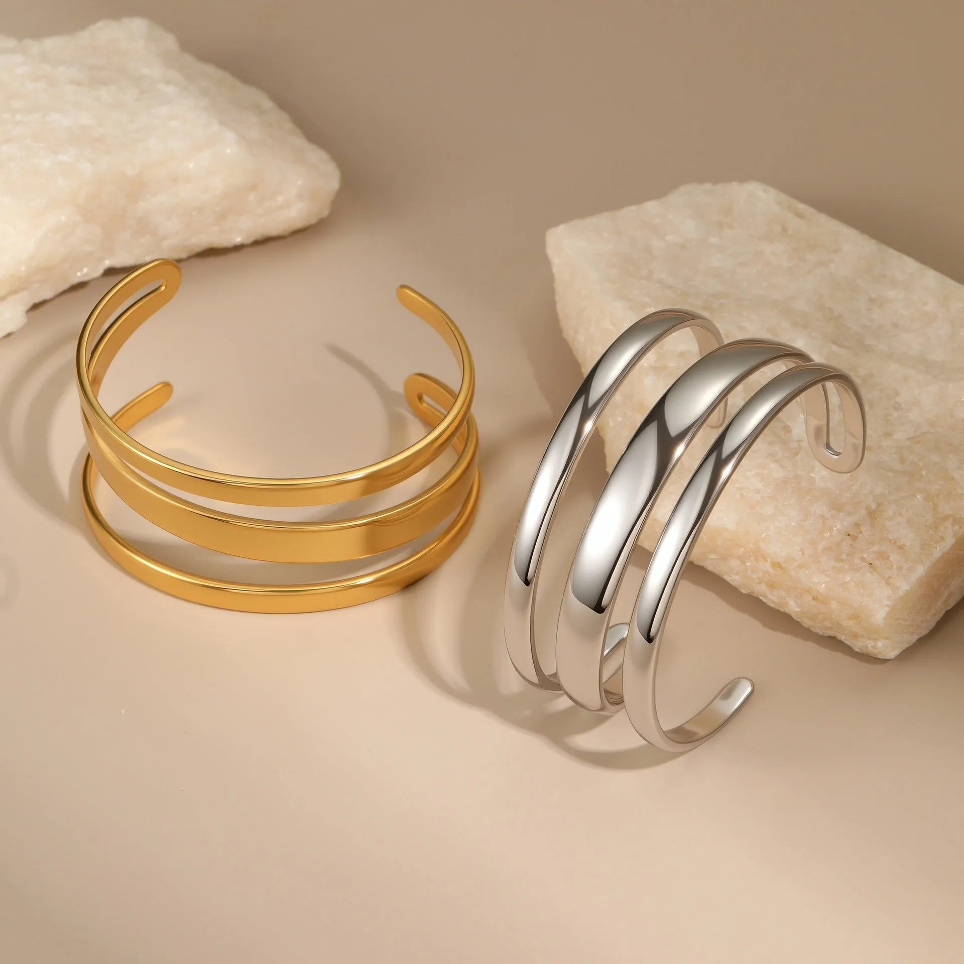 A geometric line design stainless steel bracelet with a simple opening clasp, shown in a gold electroplated finish.