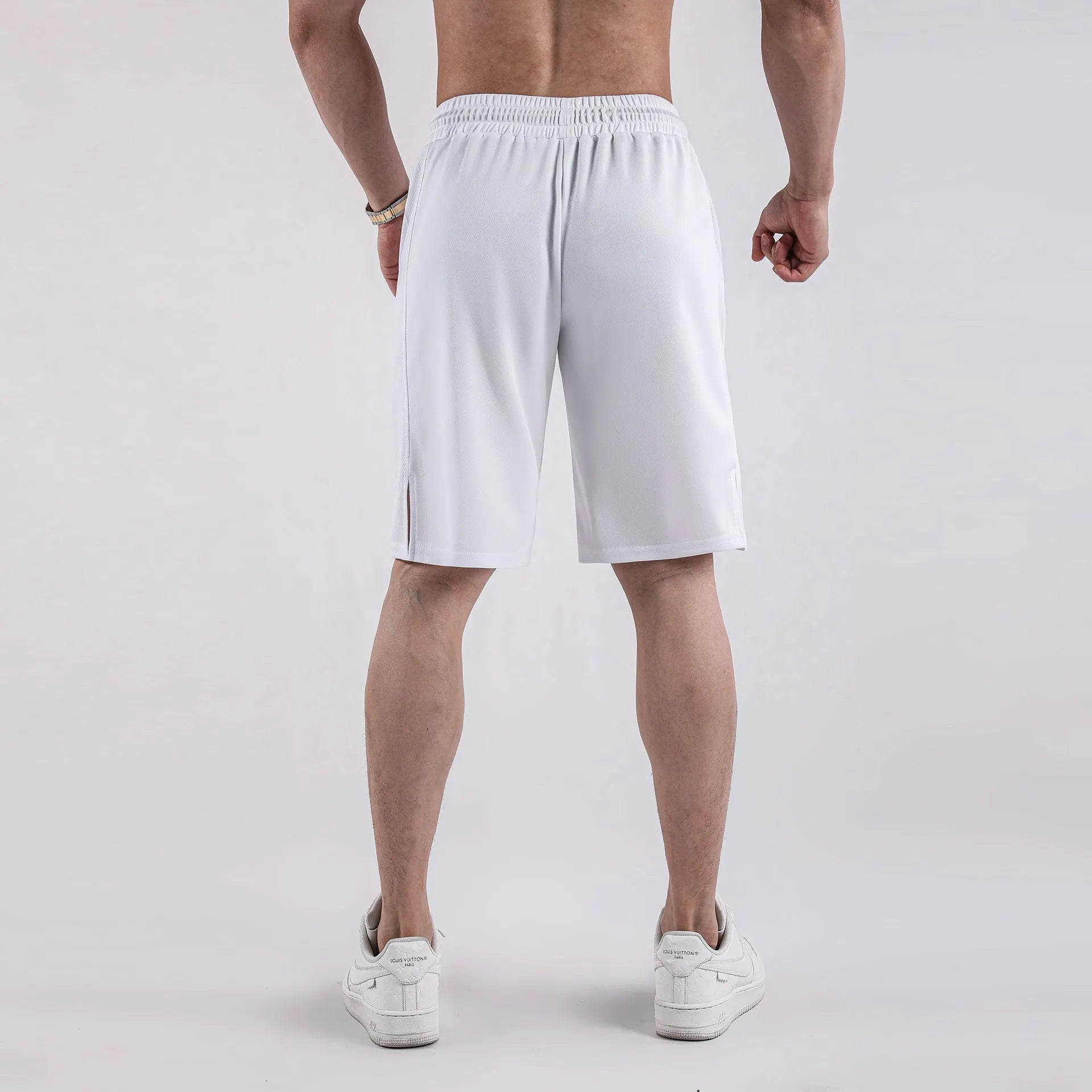 Man wearing black quick-dry mesh fitness shorts with a loose, casual fit and elasticated waistband.