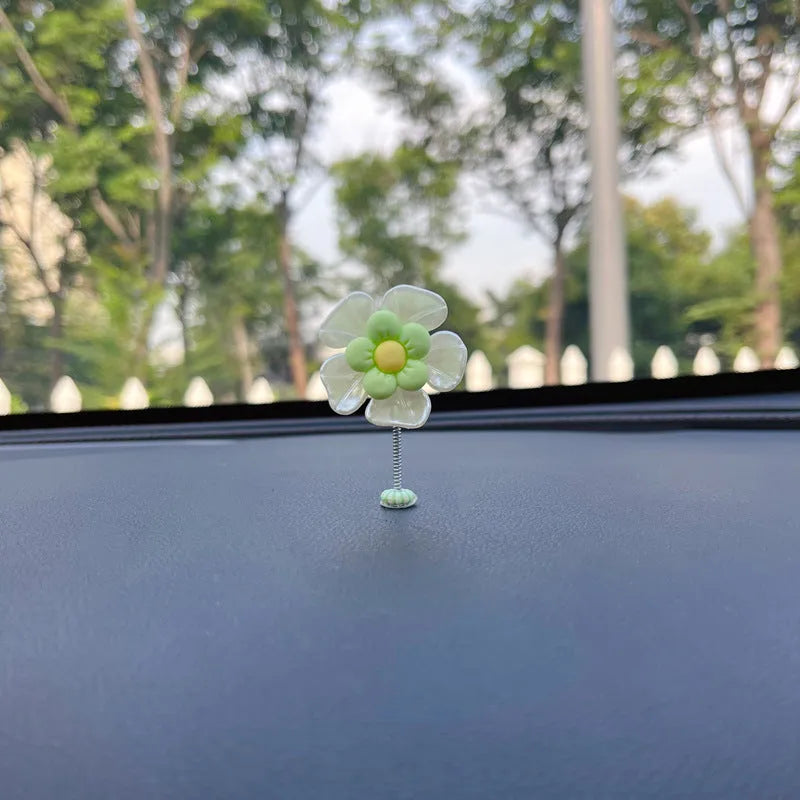 Small plastic swing decoration for car dashboard measuring 50mm by 35mm in multiple colours
