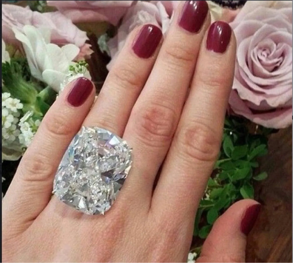 Women's simple inlaid white square diamond alloy ring with a geometric design on a finger.