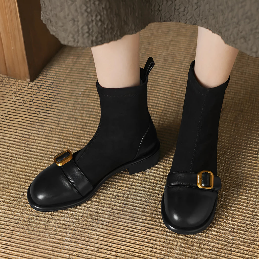 Women's black low-heel Martin ankle boots with front lace-up and belt buckle detail stitching.